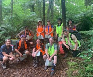 Group photo of some people in a forest wearing high vis